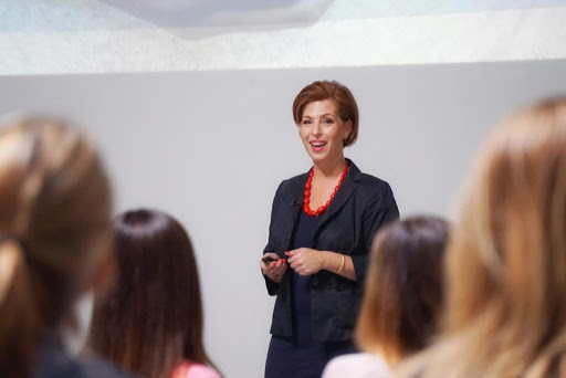 Christine giving a presentation in front of an audience